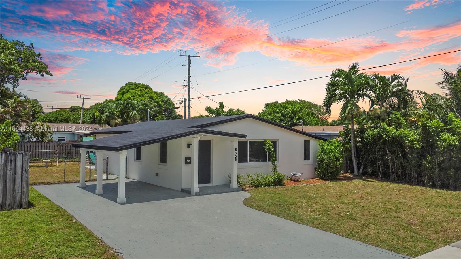 a view of a house with a backyard