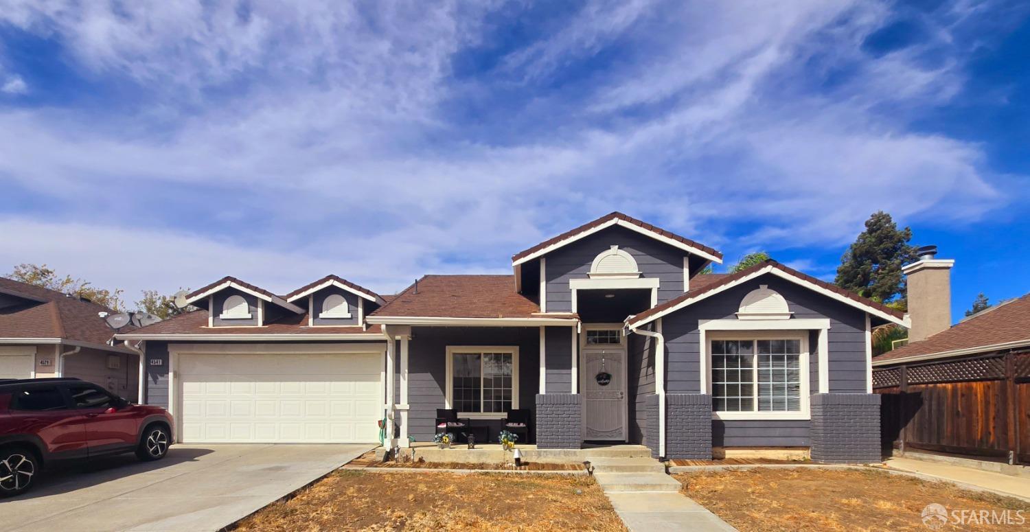 a view of a house with a yard and garage