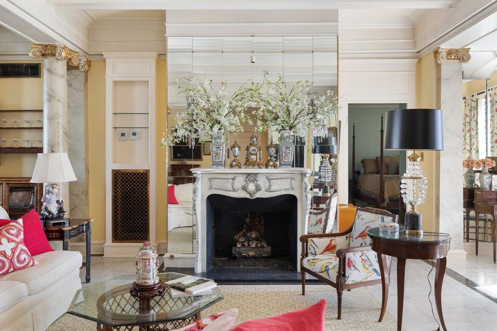 a living room with furniture a fireplace and a table