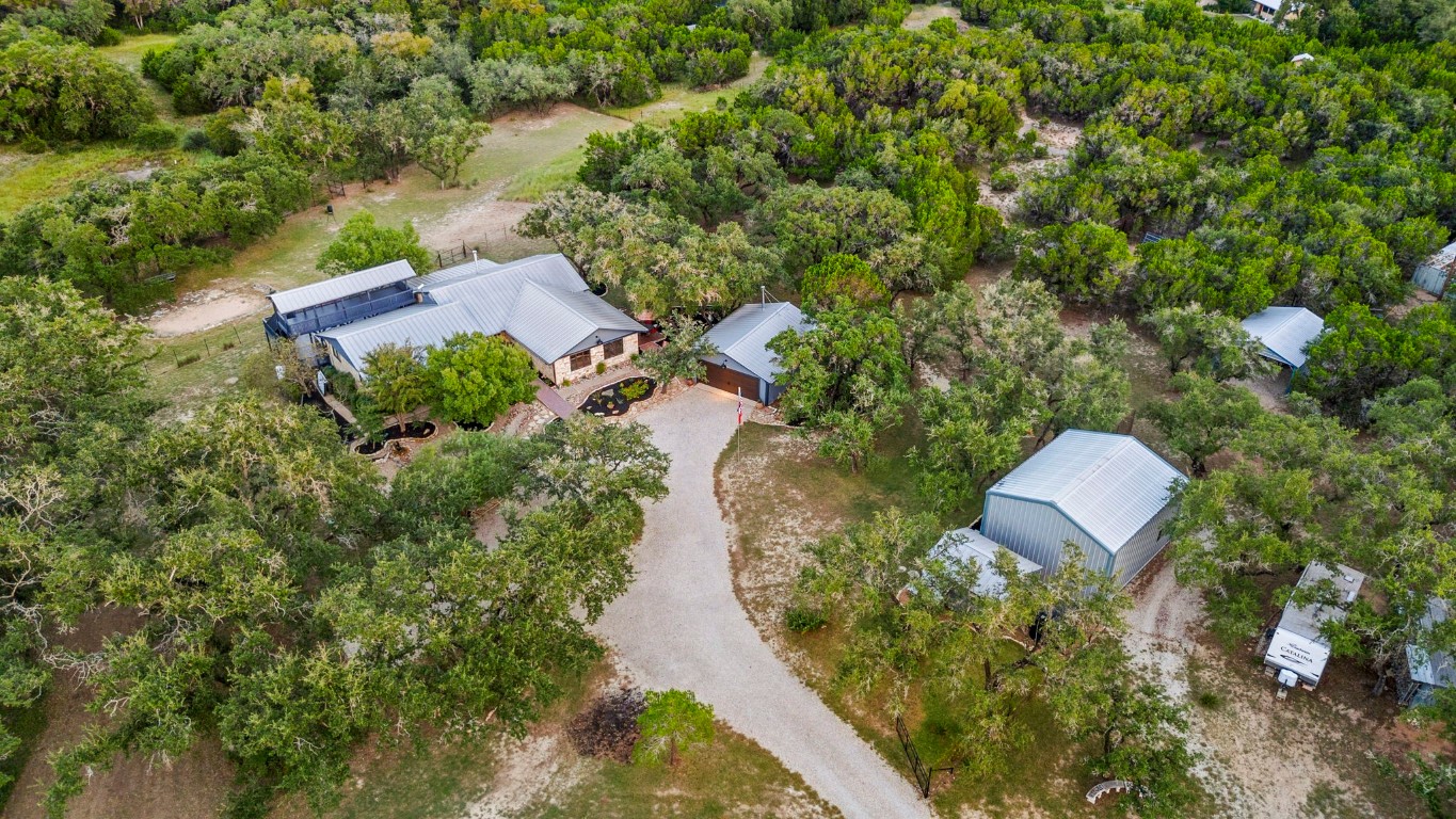 an aerial view of a house with a yard and garden