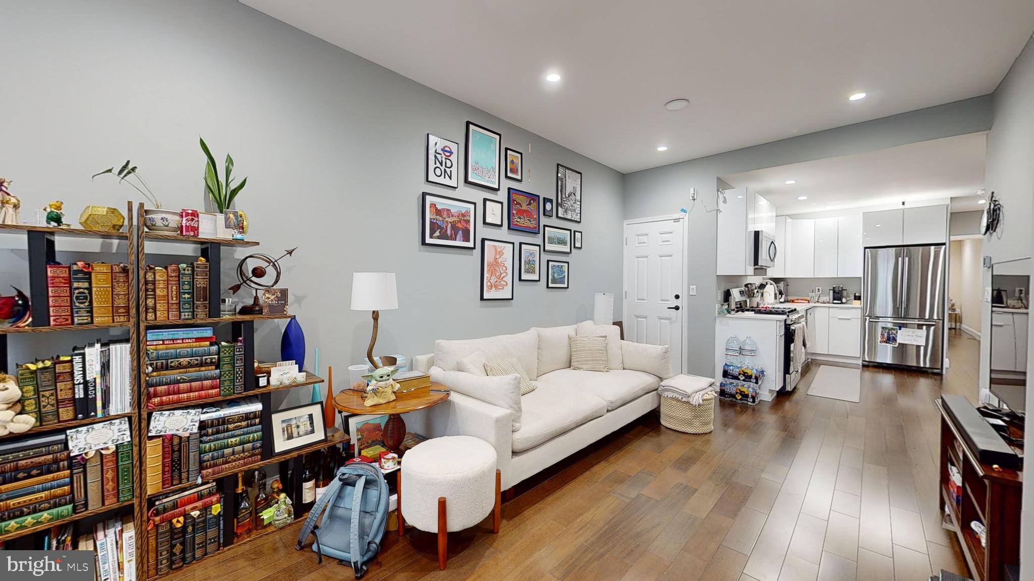 a living room with furniture and a book shelf