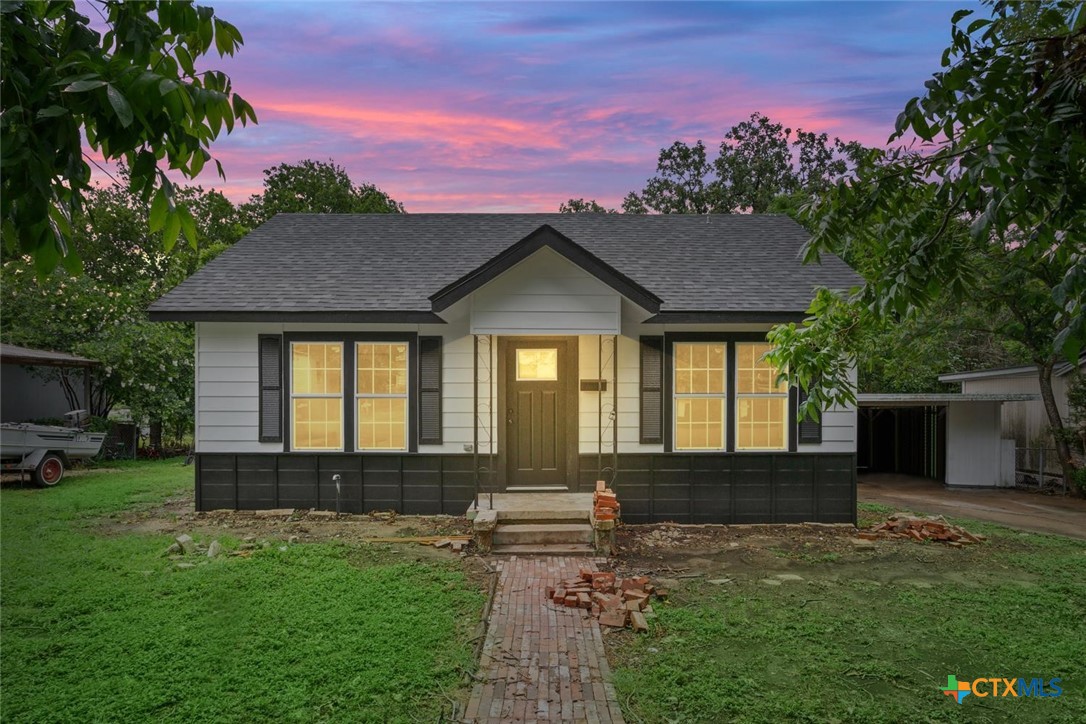 a front view of a house with a yard