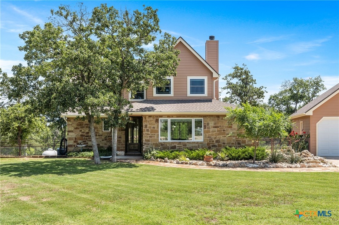 a front view of house with yard and green space