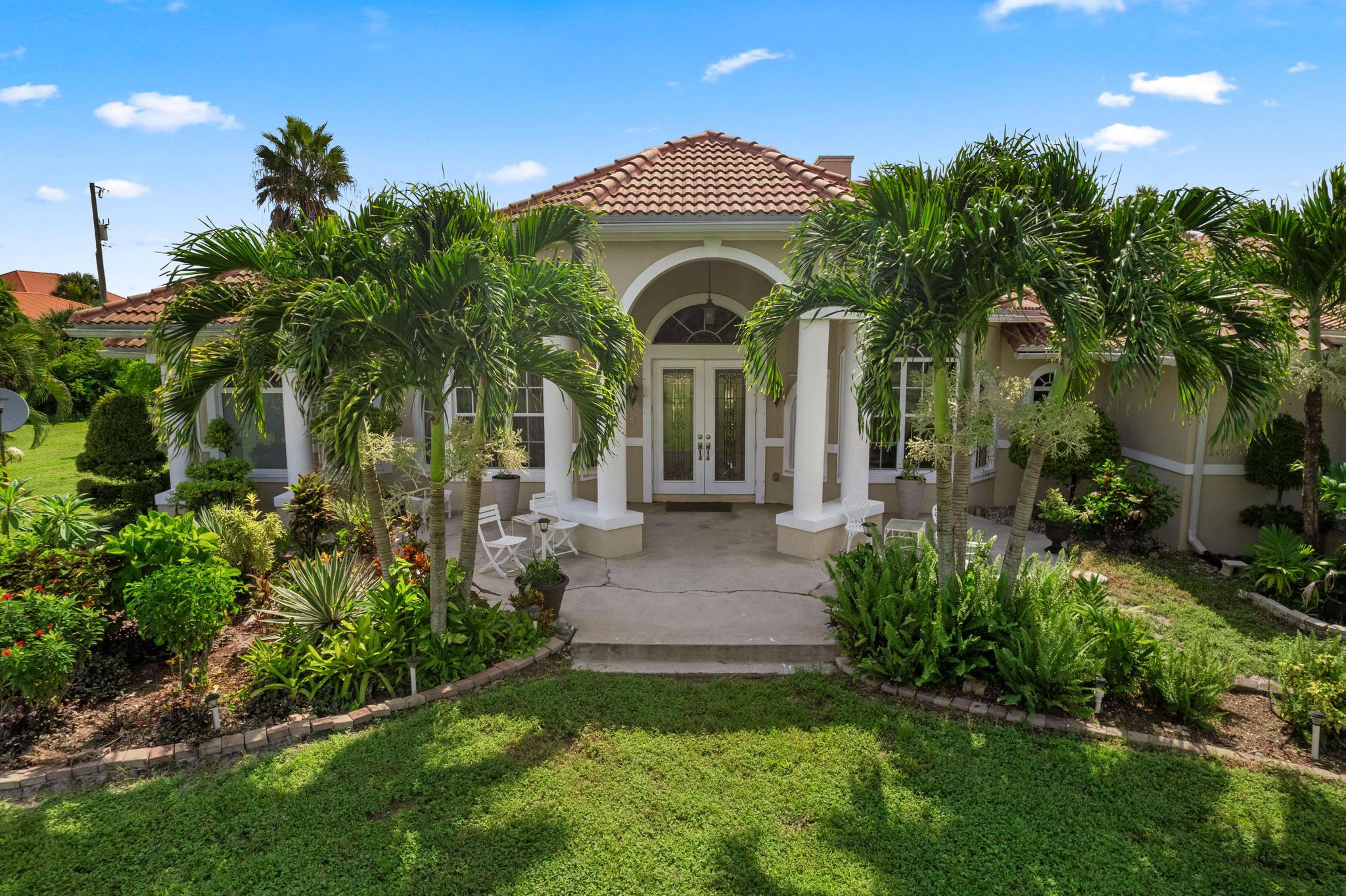 a front view of a house with a garden