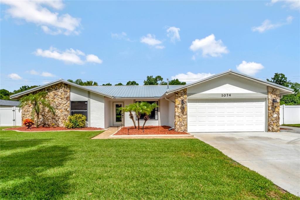 a view of a house with a yard and garage