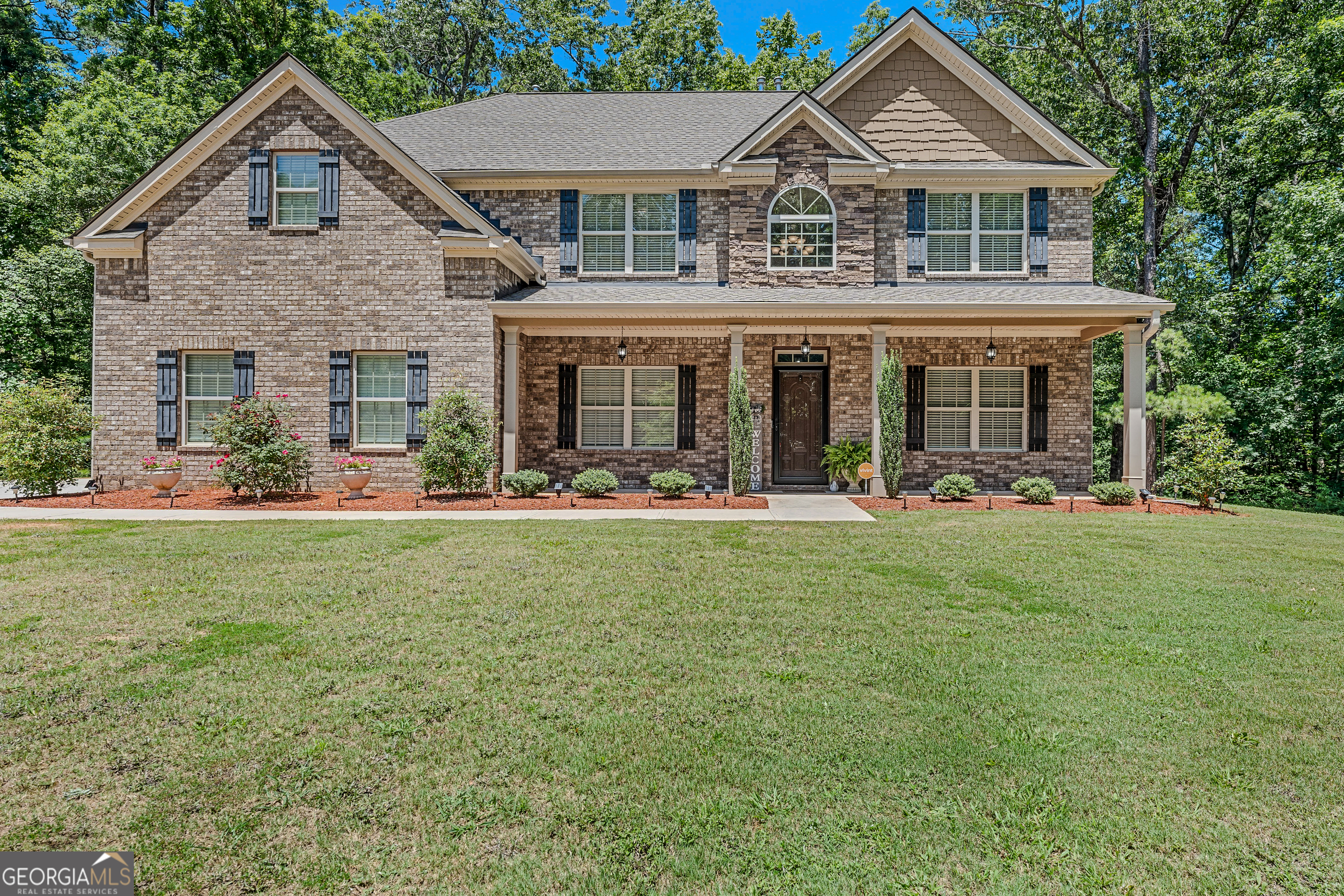 a front view of a house with a yard