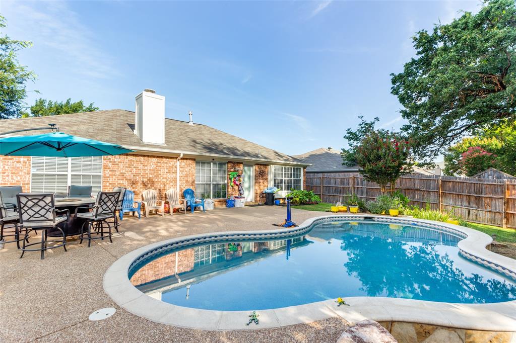 a view of a swimming pool with outdoor seating