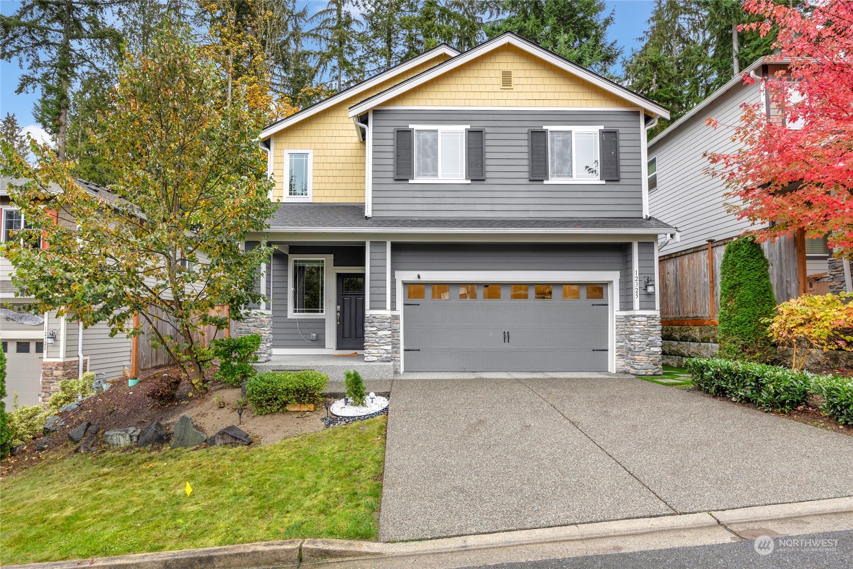 a front view of a house with a yard and garage