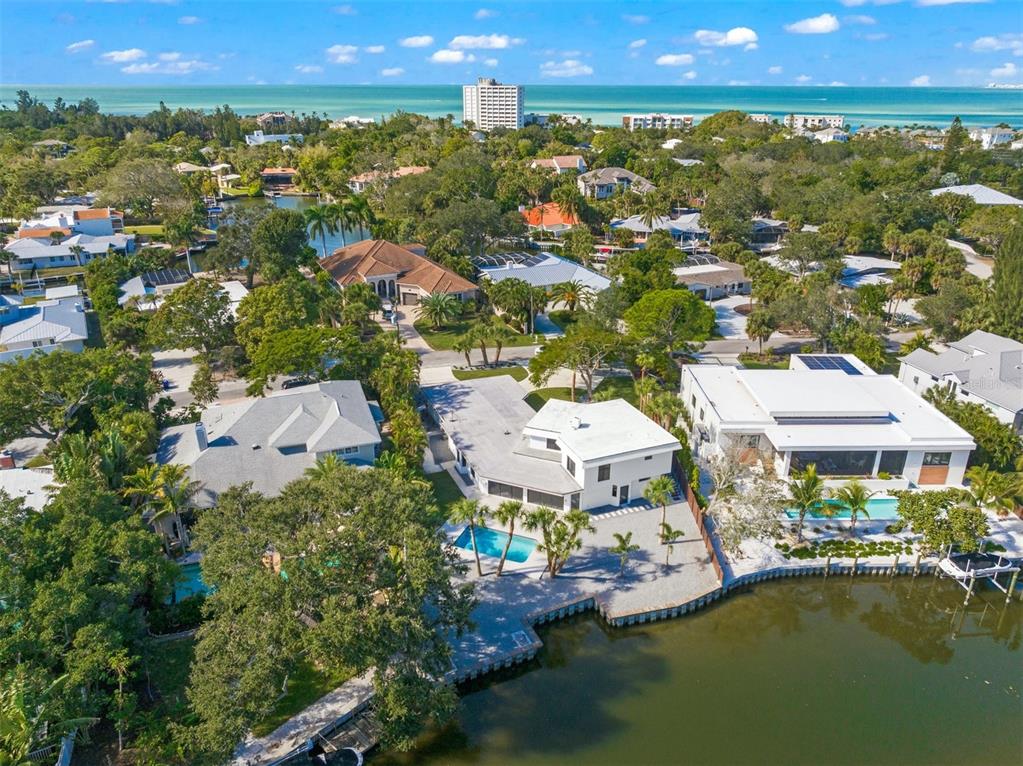 an aerial view of residential houses with outdoor space and swimming pool