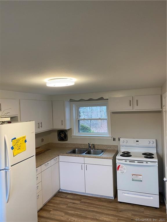 a kitchen with a stove a sink and a refrigerator