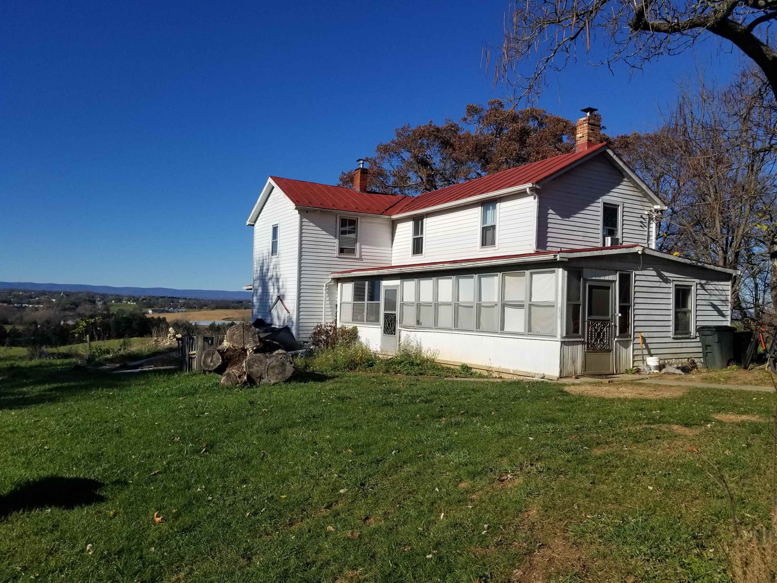 a view of house with yard and sitting area