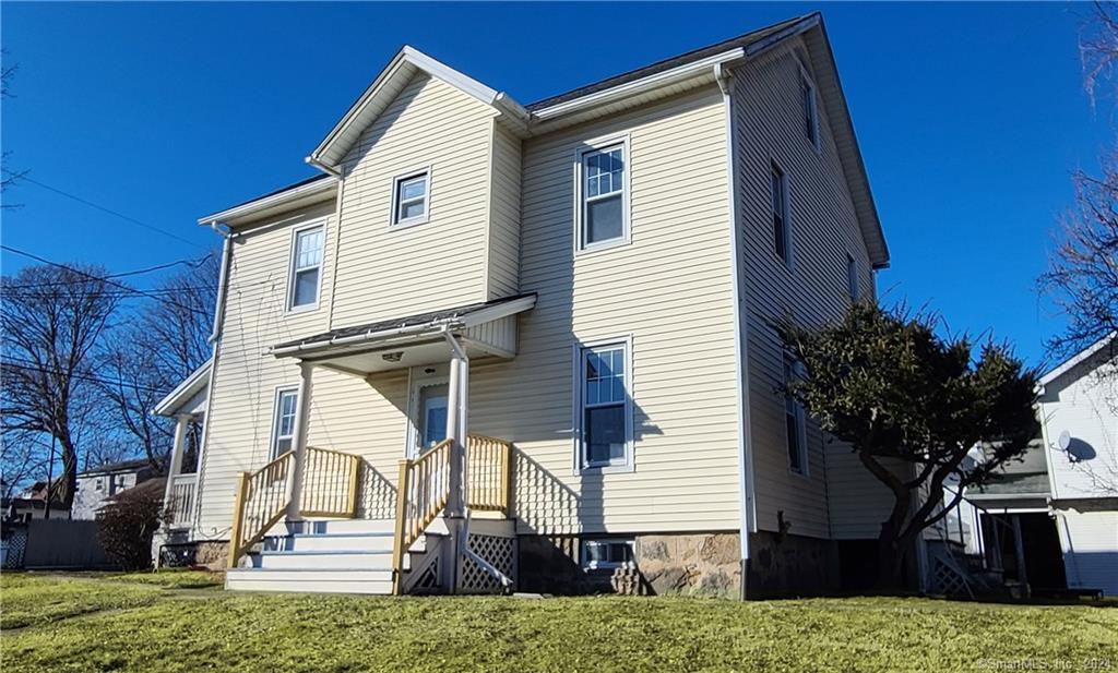 a view of front of house with stairs yard