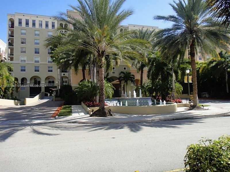 a view of street with palm trees