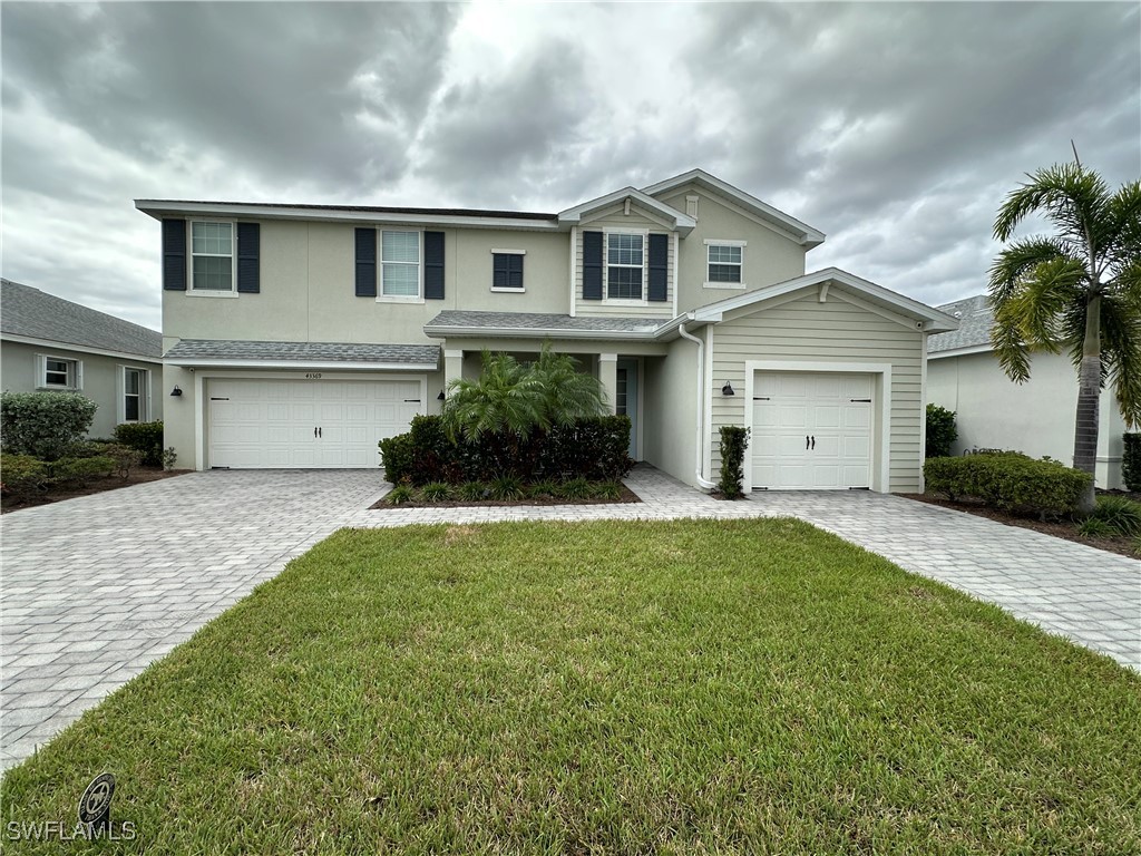 a front view of a house with a yard and garage