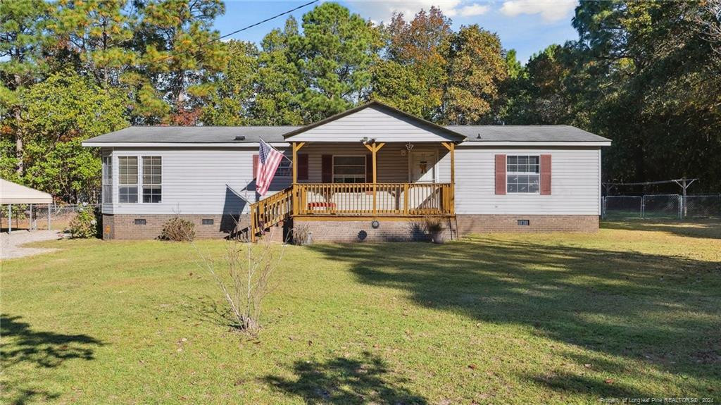 a front view of a house with a yard table and chairs