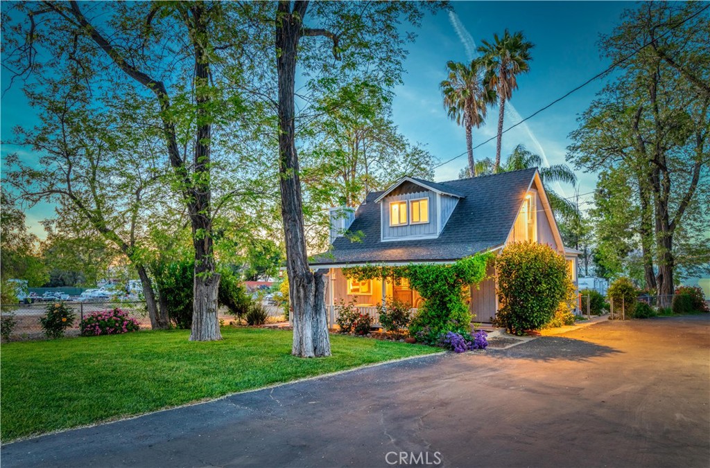 a view of a house with a yard and tree s