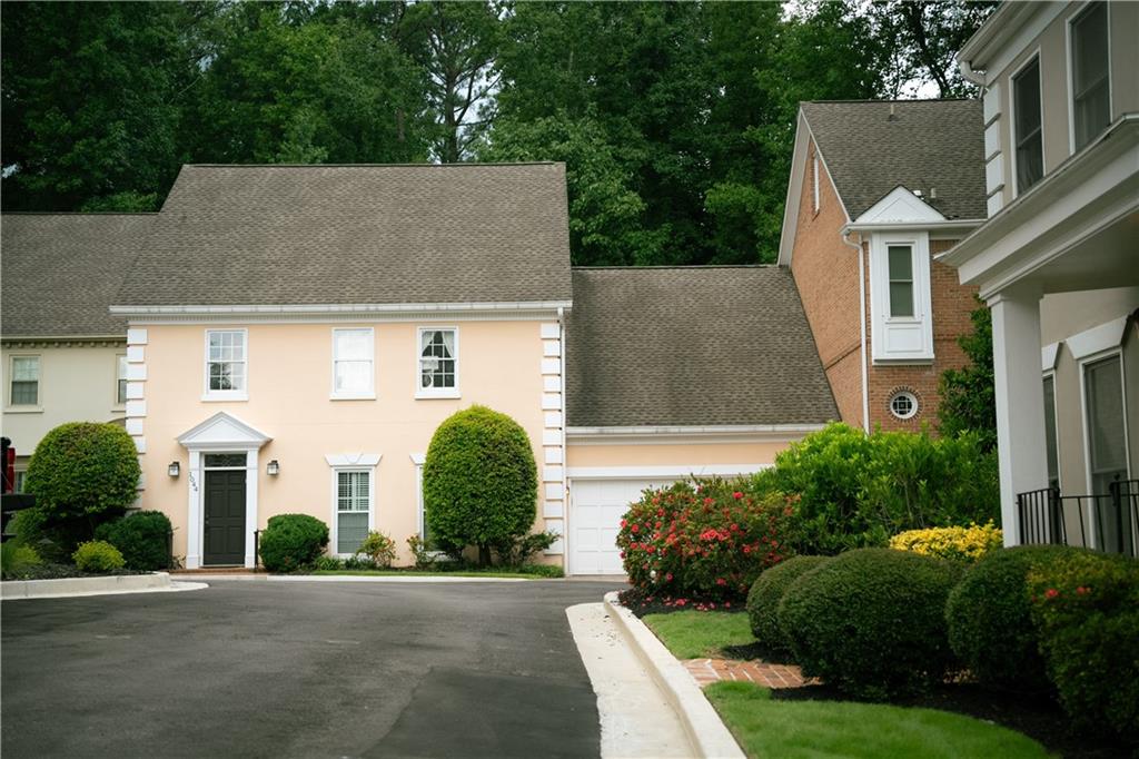 front view of house with a yard and potted plants