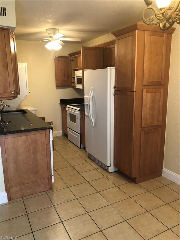 a kitchen with a refrigerator and a sink