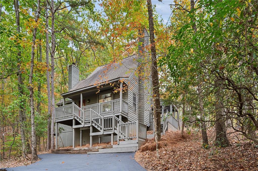 a front view of a house with a tree