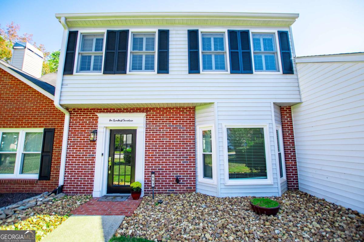 a view of a brick house with a large windows