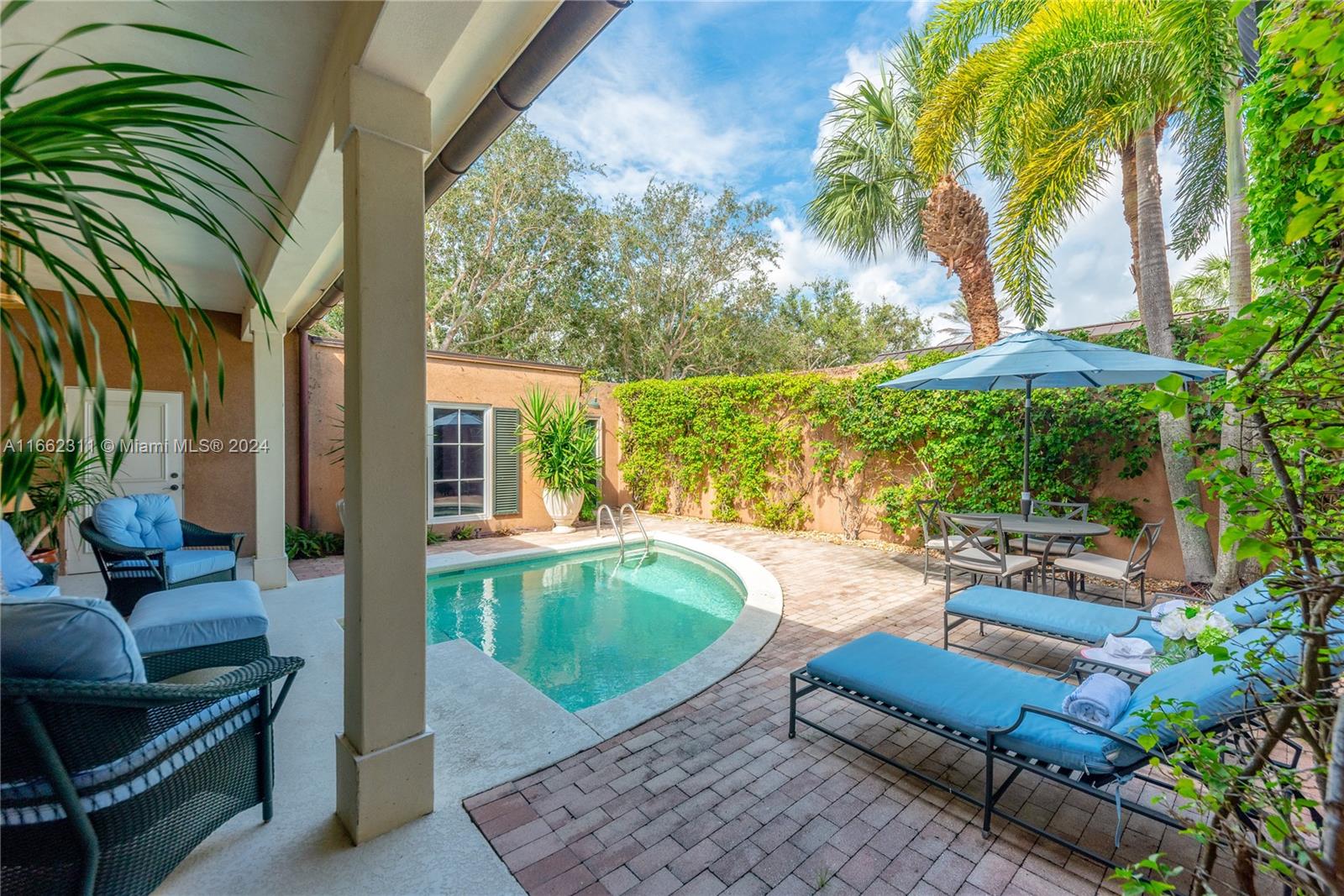 a swimming pool with outdoor seating and yard