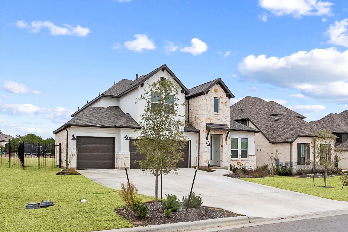 a front view of a house with a yard and garage