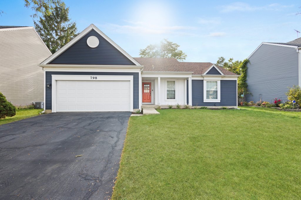 a front view of a house with a yard and garage