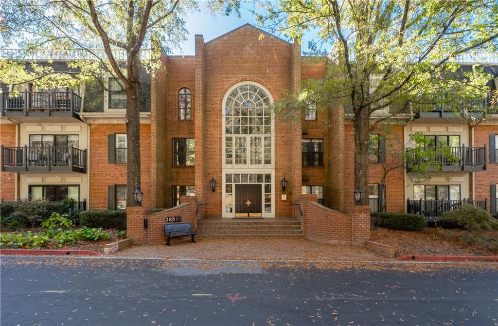 a front view of a building with a garden