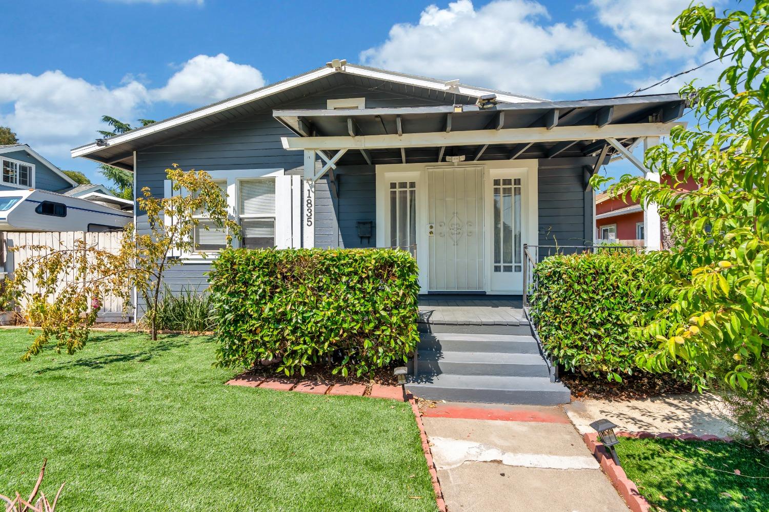 a front view of a house with garden