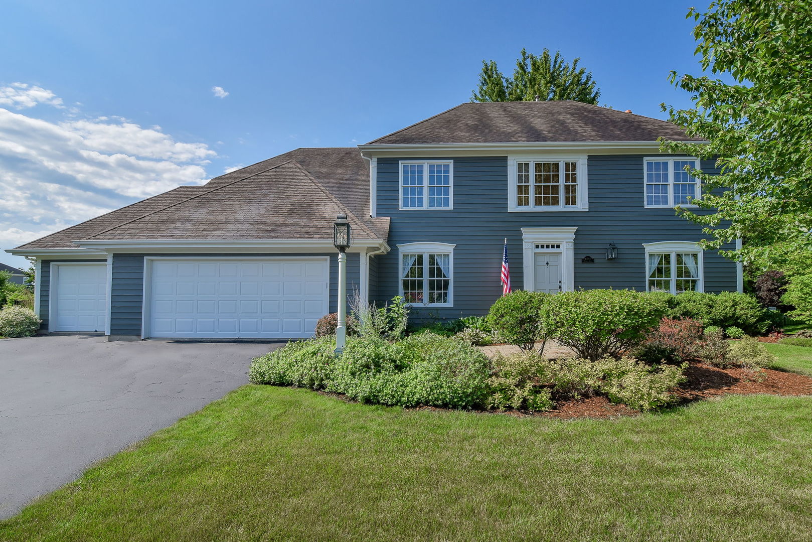 a front view of a house with a garden