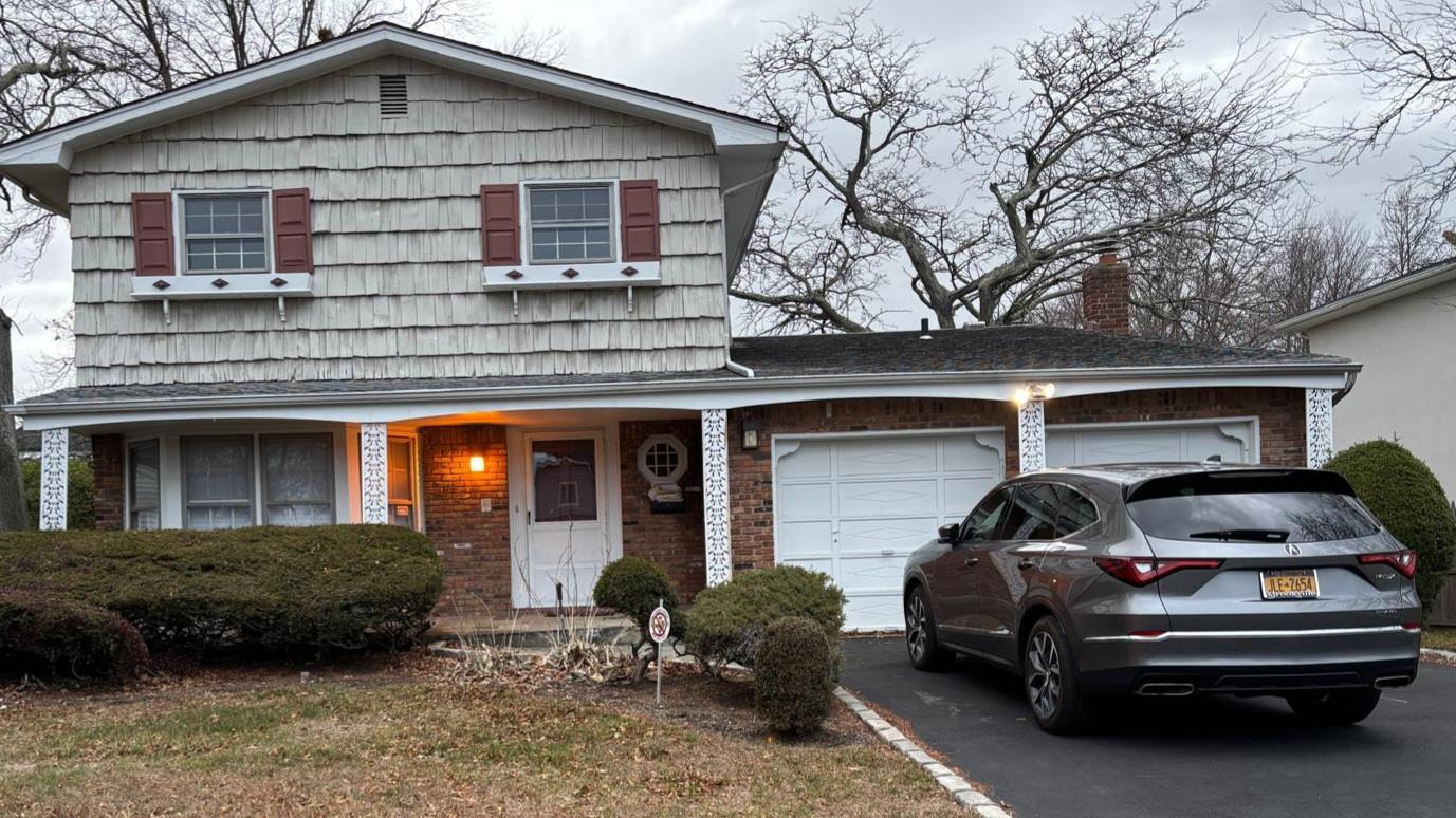 a car parked in front of a house