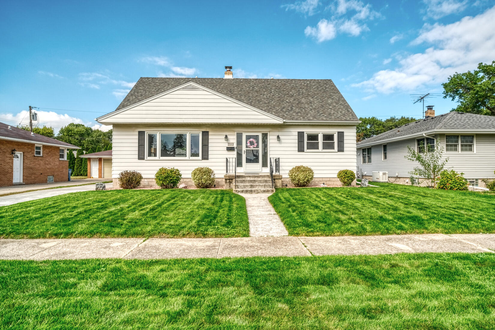 a front view of a house with a garden