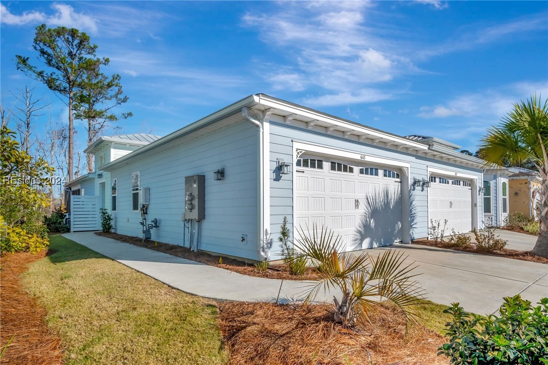 View of side of home featuring a garage