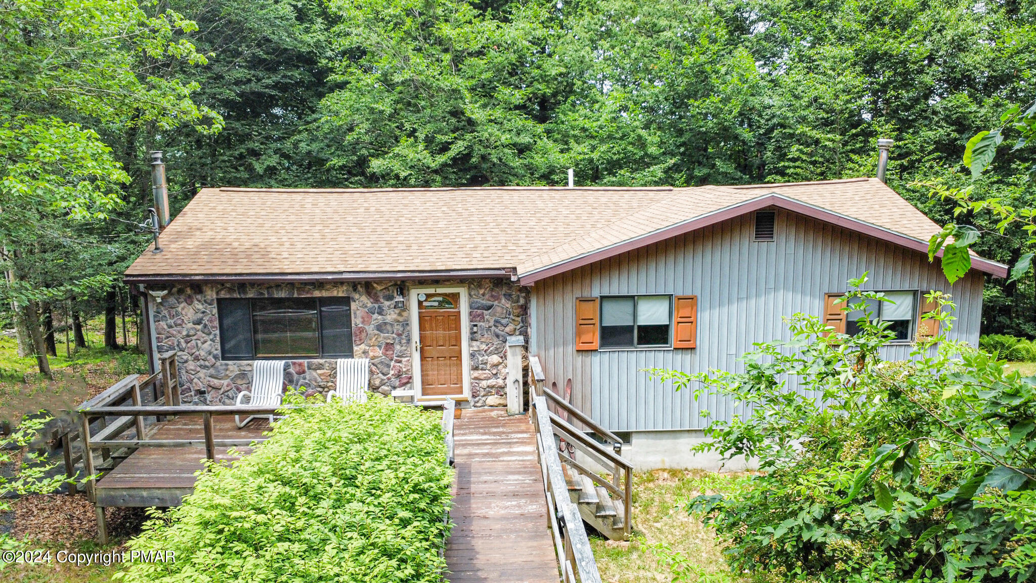 a front view of house with yard and green space