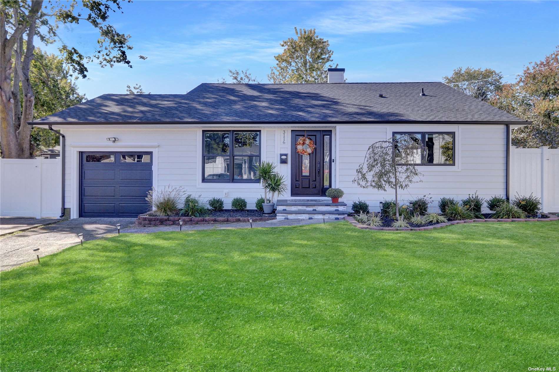 a front view of house with yard and outdoor seating