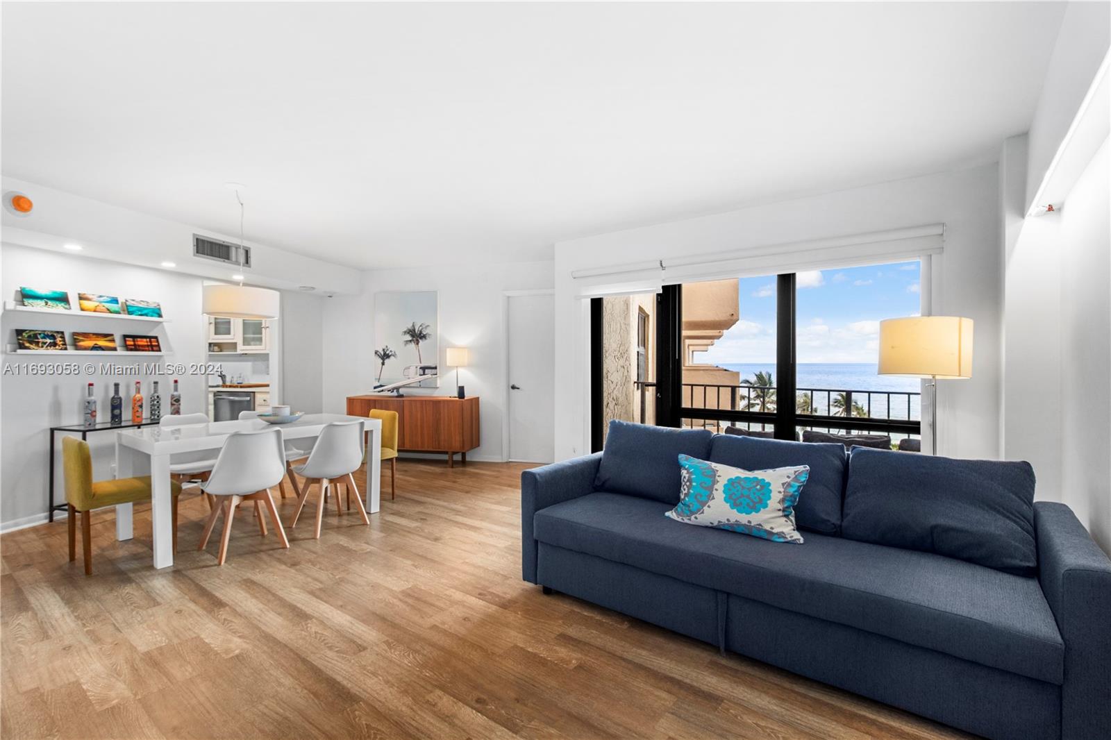 a living room with furniture kitchen view and a table