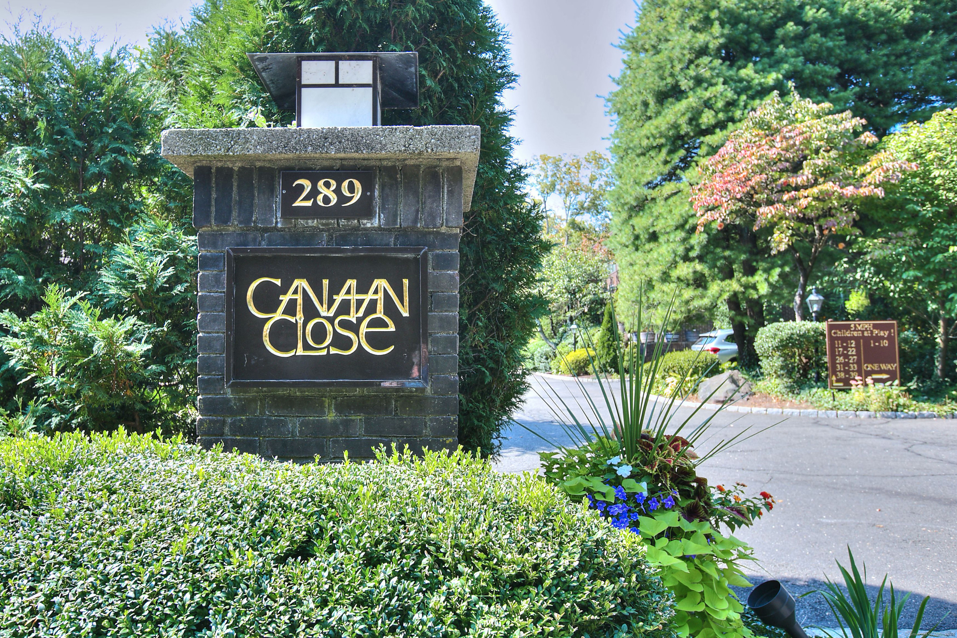 a sign broad in front of flowers