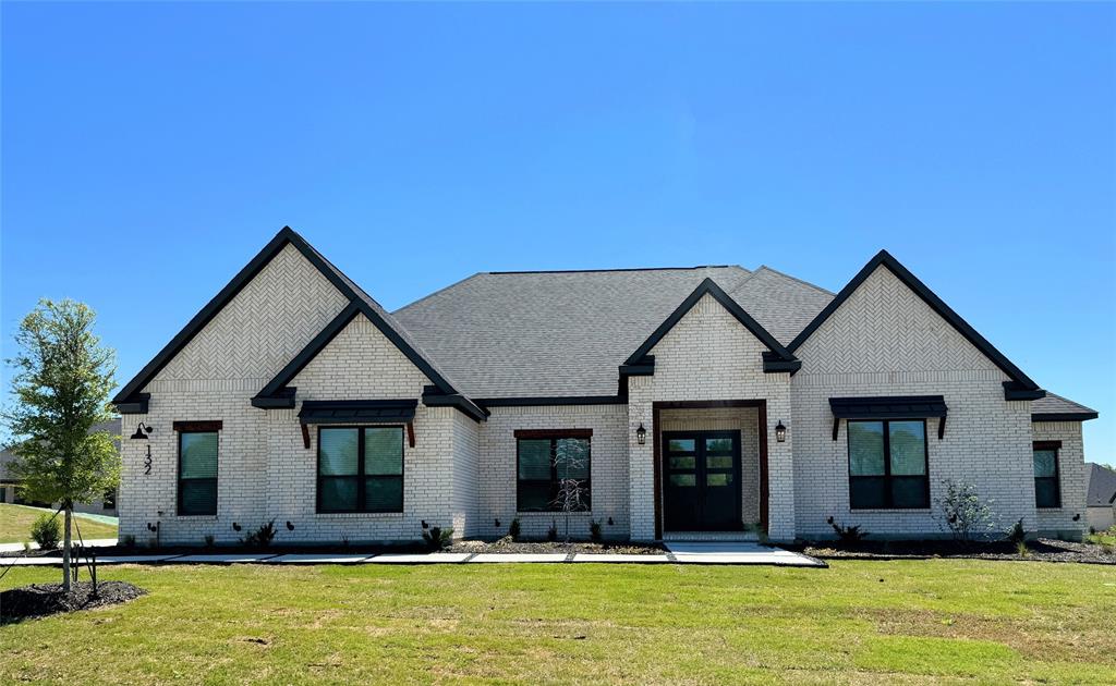 a front view of a house with a yard