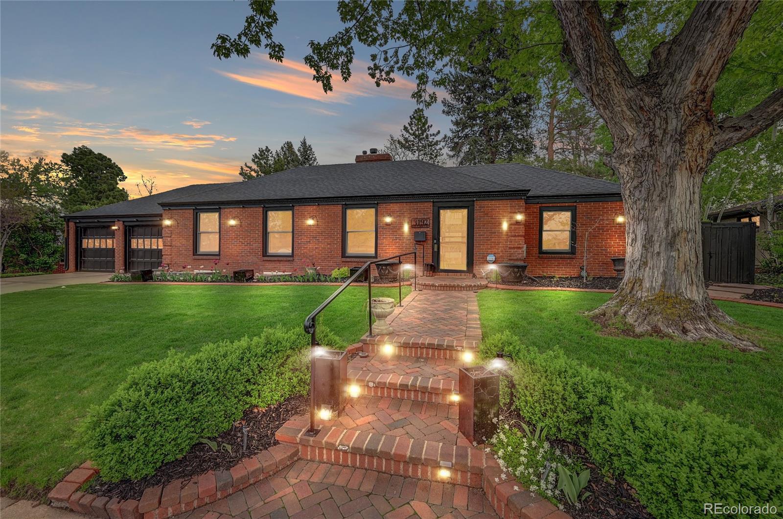 a front view of a house with a yard and outdoor seating