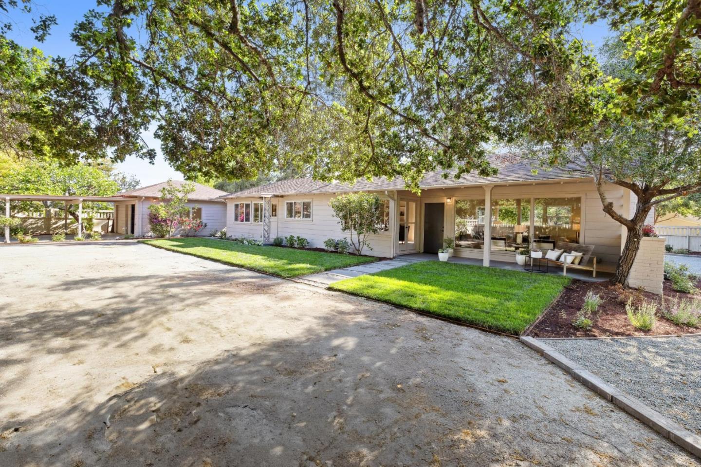 a view of a house with a yard and sitting area