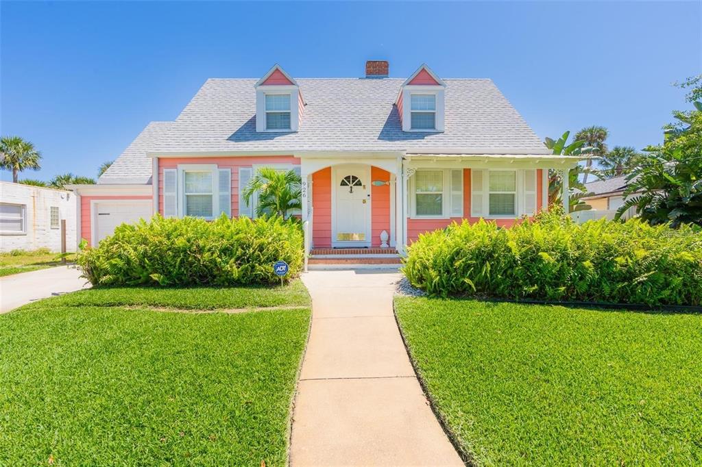 a front view of a house with garden