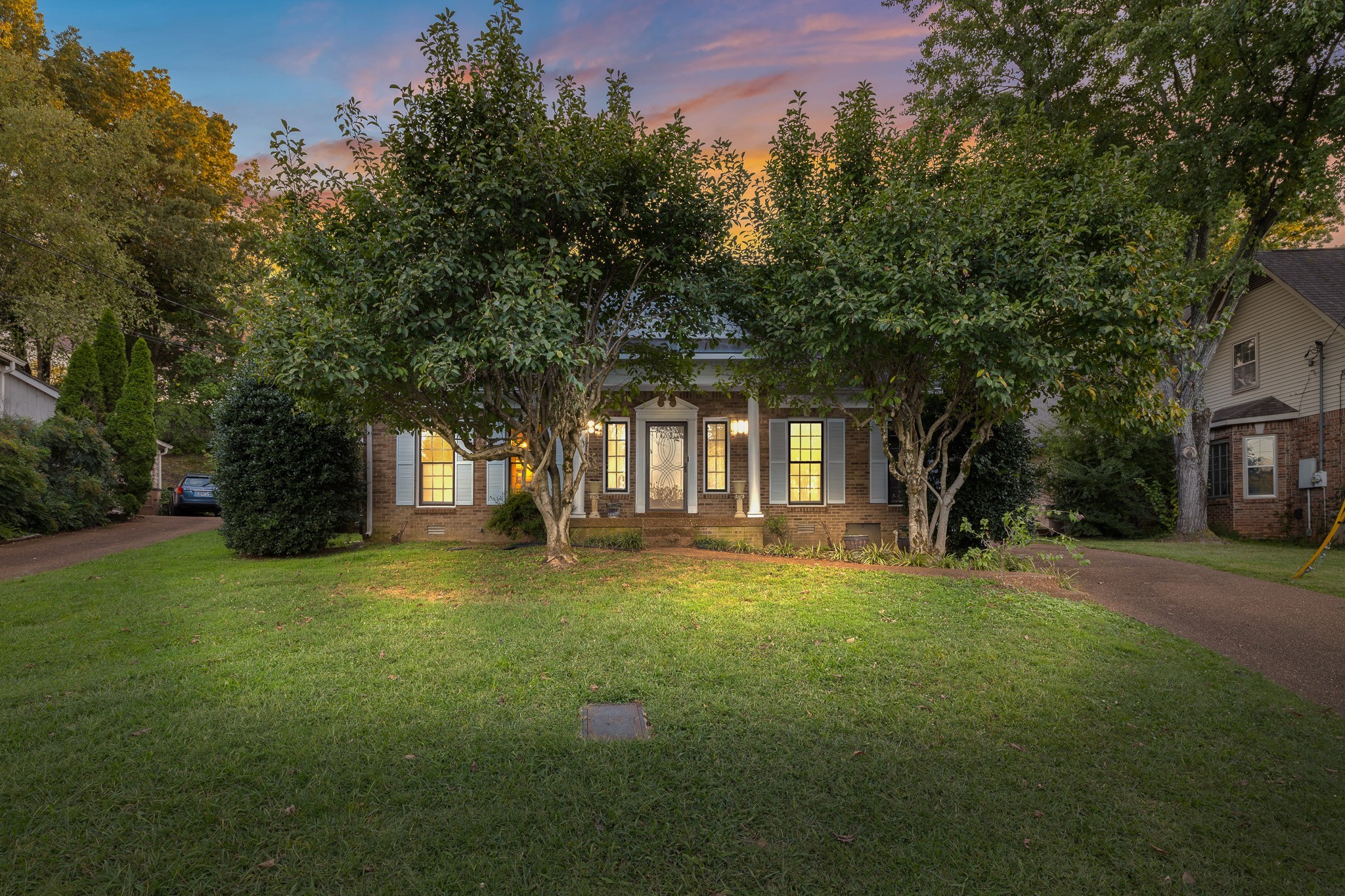 a view of a trees in front of a house with a big yard