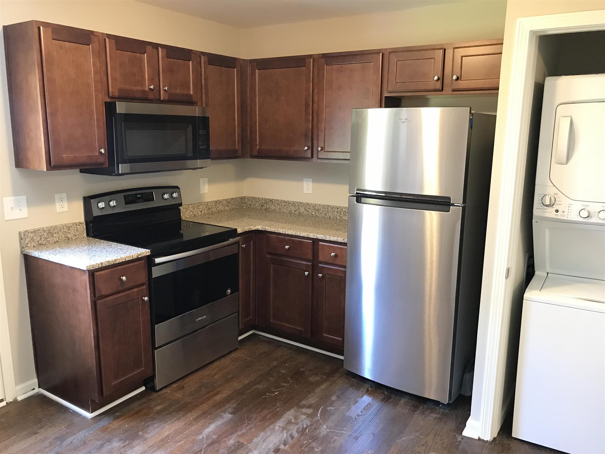 a kitchen with a refrigerator sink and microwave