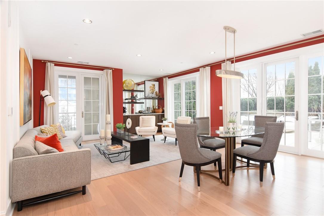 a living room with furniture and floor to ceiling windows