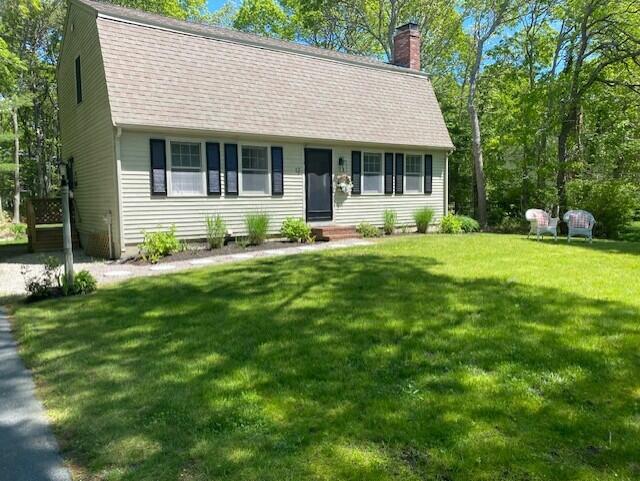 a front view of a house with a garden and porch