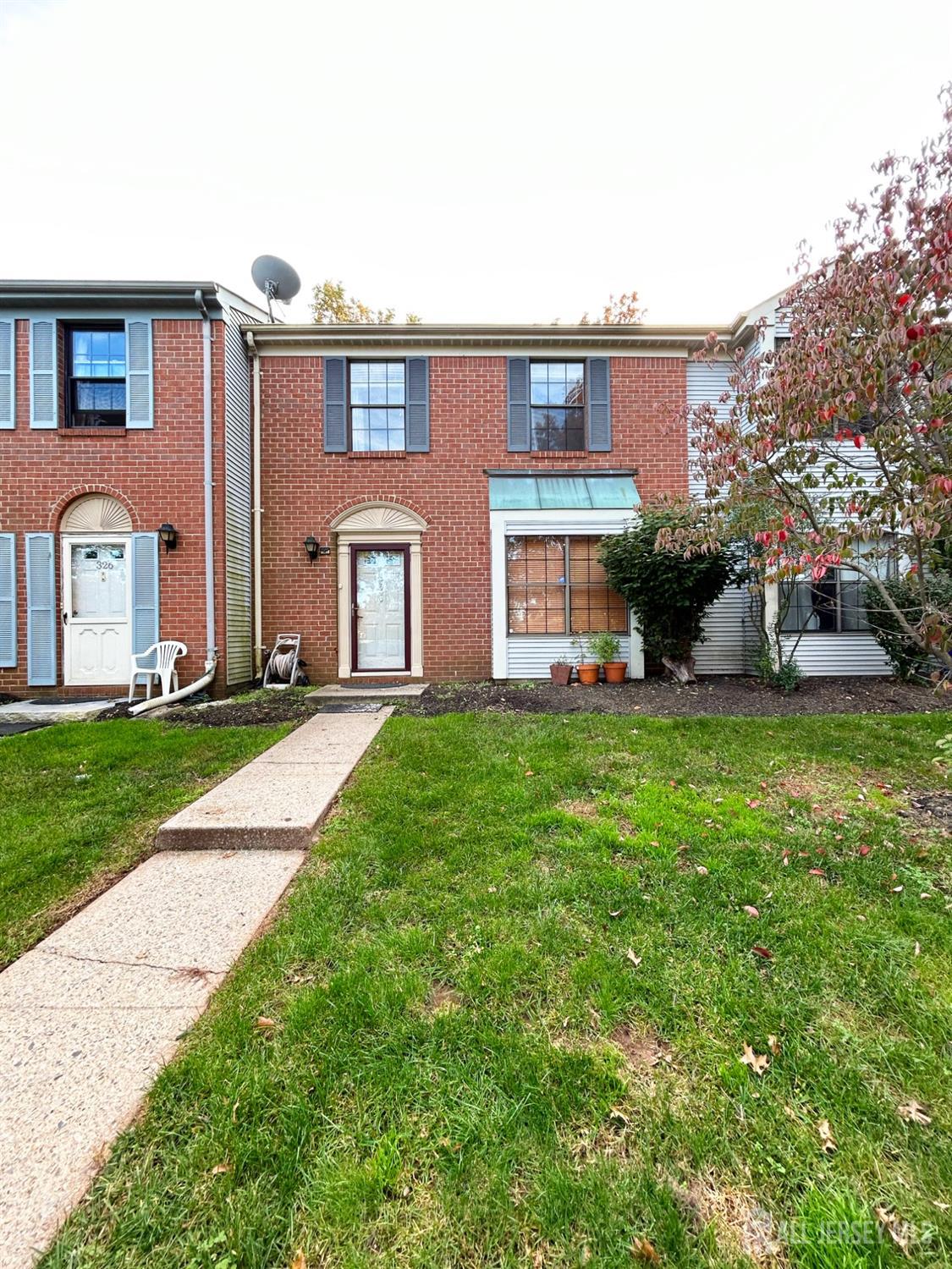 a front view of a house with garden and porch