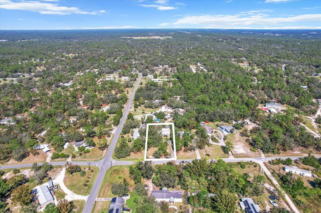 an aerial view of residential building with green space