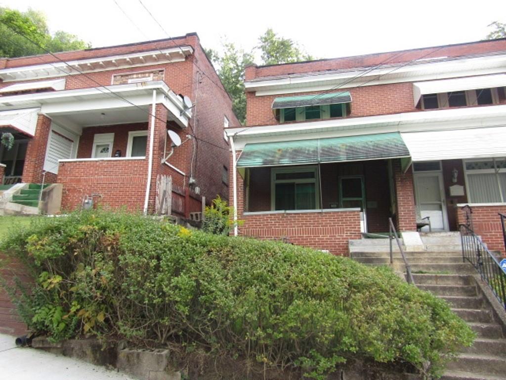 a view of a brick house with many windows