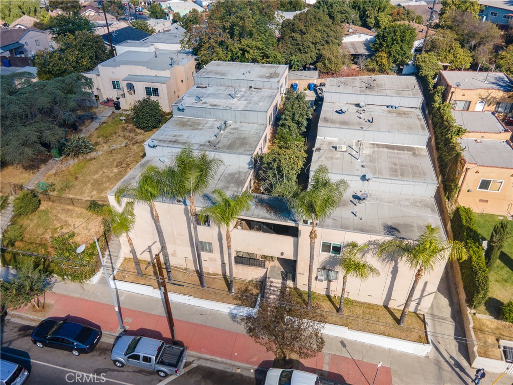 an aerial view of a swimming pool with outdoor seating