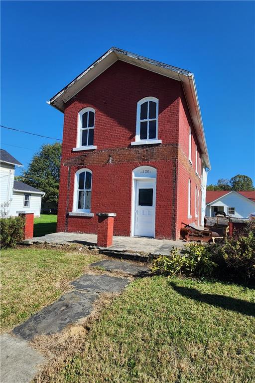 a front view of house with yard and trees